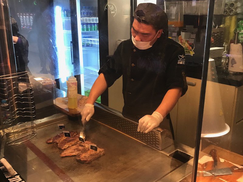 The kiosk's staff will ready your meat right in front of you