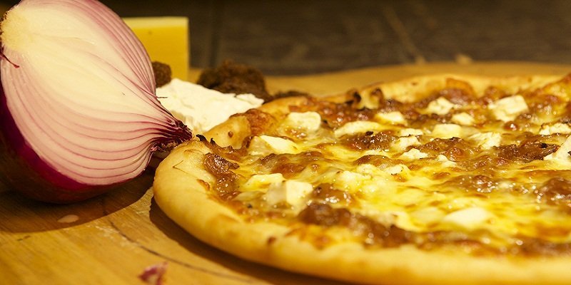 The Greek Champion: a delicious combination of caramelized onions, feta cheese, and mozzarella