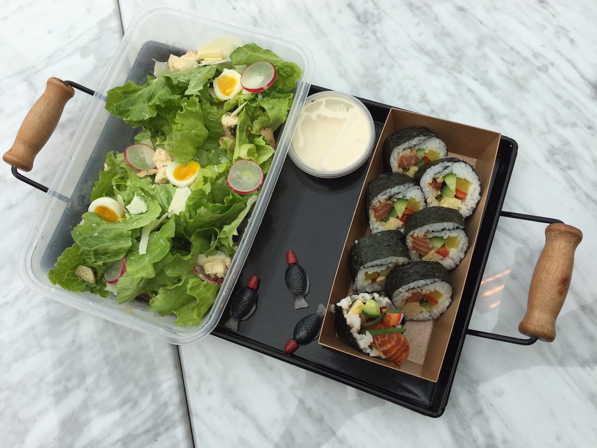 Caesar salad and salmon sushi