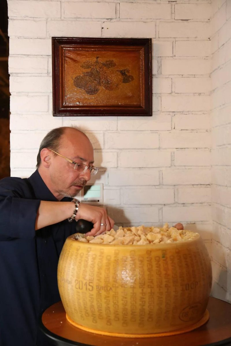 Carving up a block of 2015 Parmigiano-Reggiano