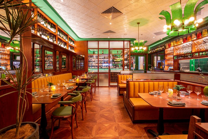 Root 85's interior plays into the word "root" with an earthy green and wood design scheme