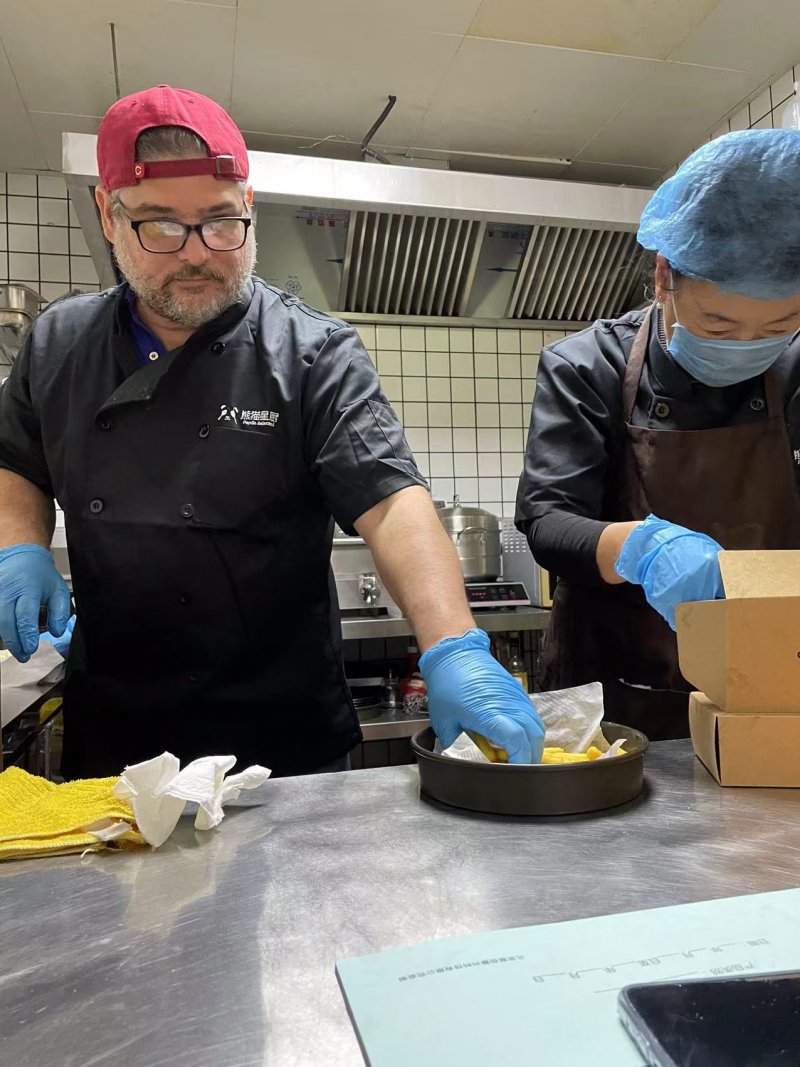 Andino owner Antonio Frias preparing andinitos to go
