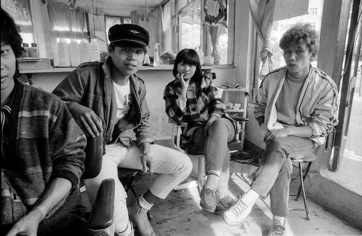 Young Cantonese hairdressers wait for customers at one of the capital's first privately run hair salons - Beijing, 1987