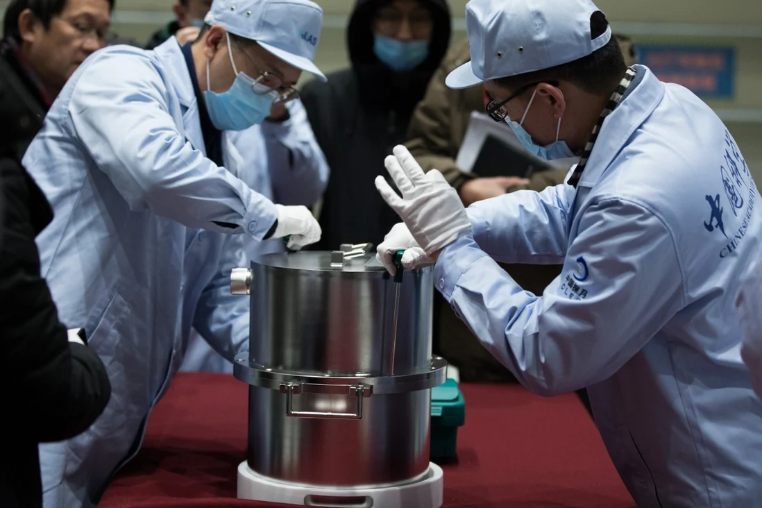 Scientists extract the lunar samples from a container