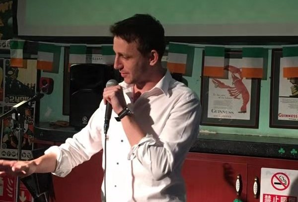 A white male comedian at an open mic. Very original.
