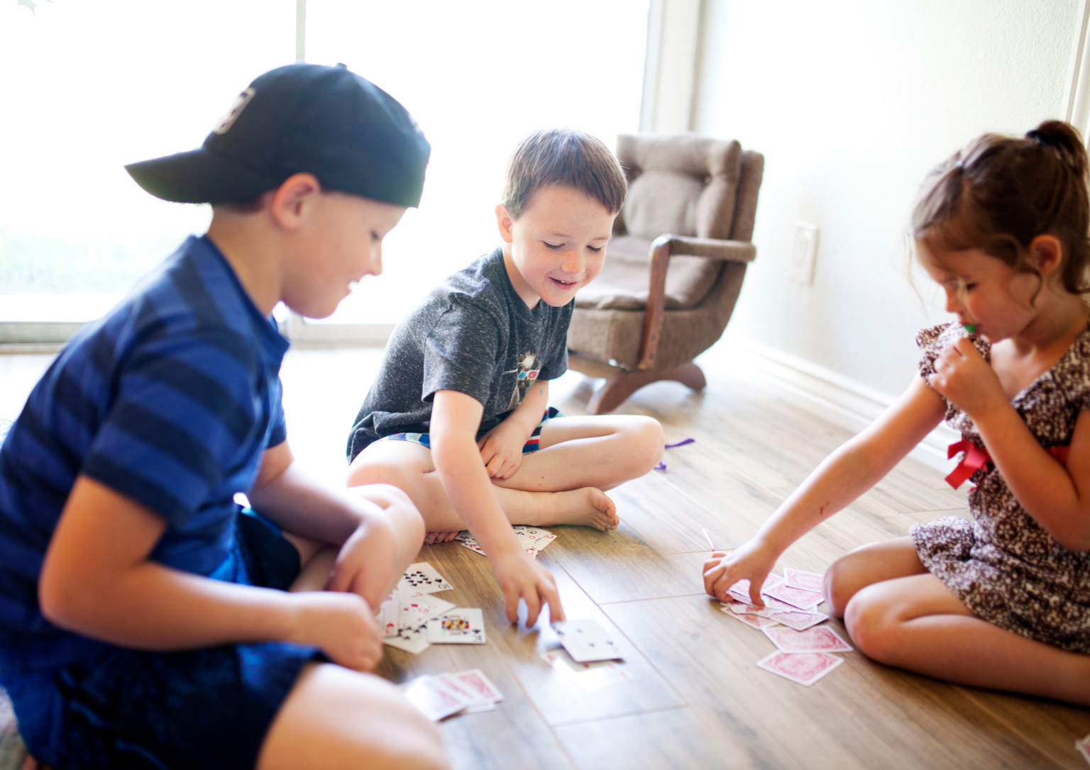 Group of Asian friends playing card games for fun in a hostel